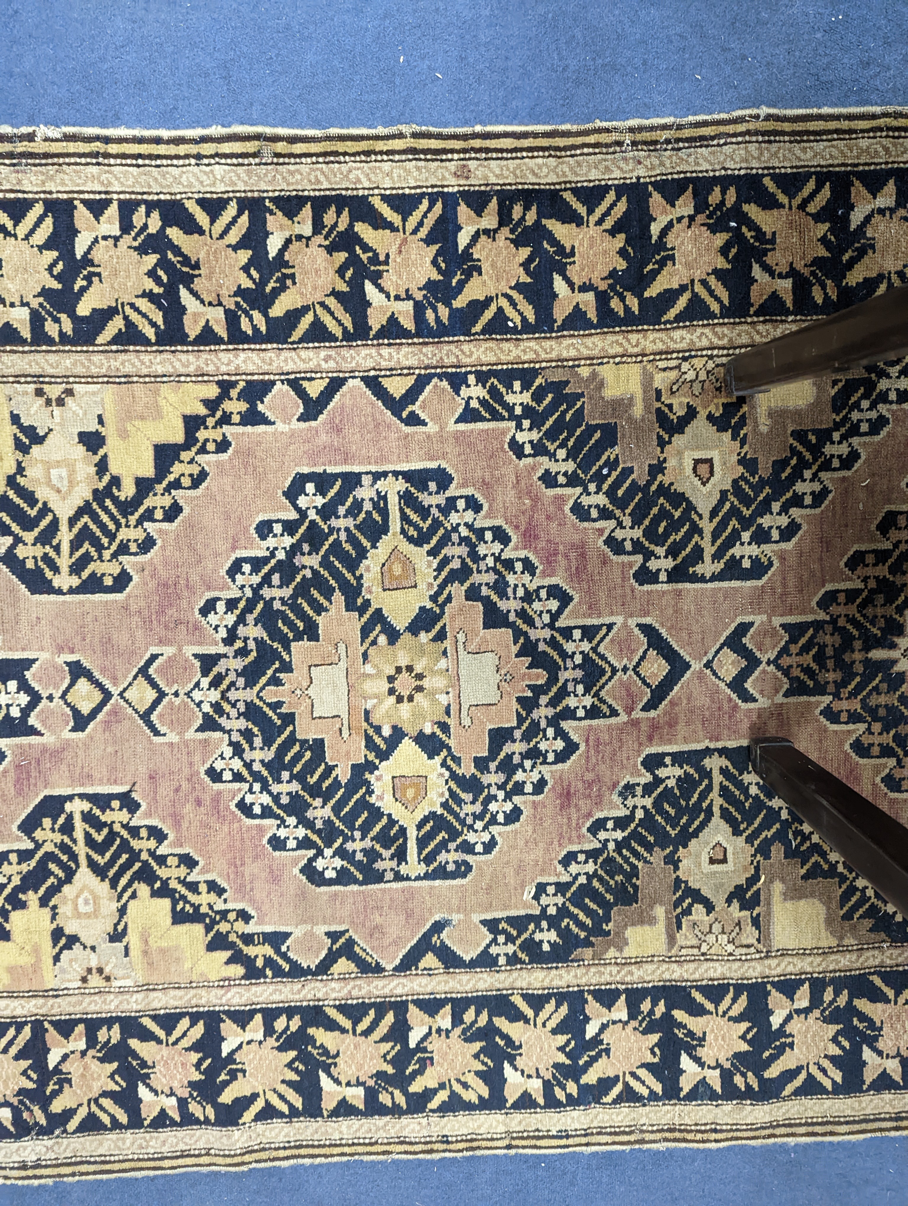 A Caucasian pink ground runner, woven with geometric devices, 483 x 107cm